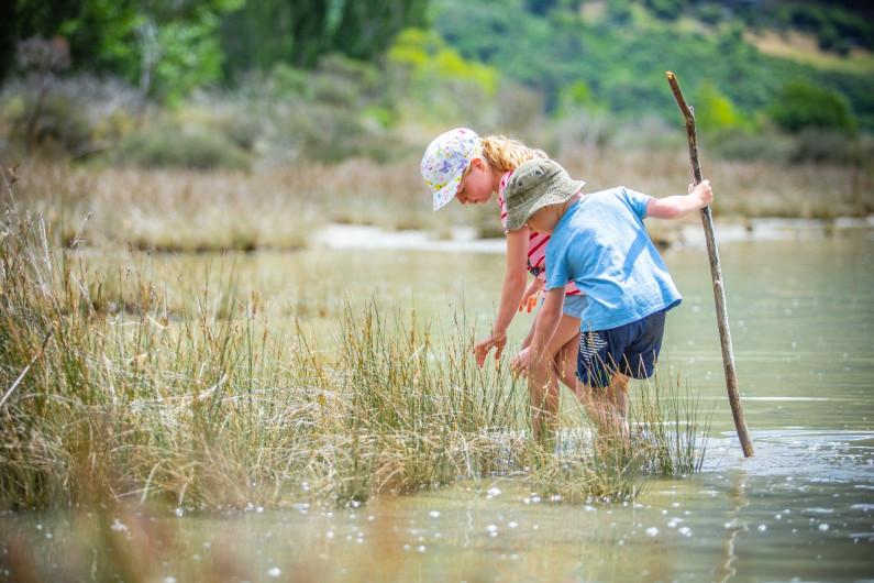 Children exploring a waterway.