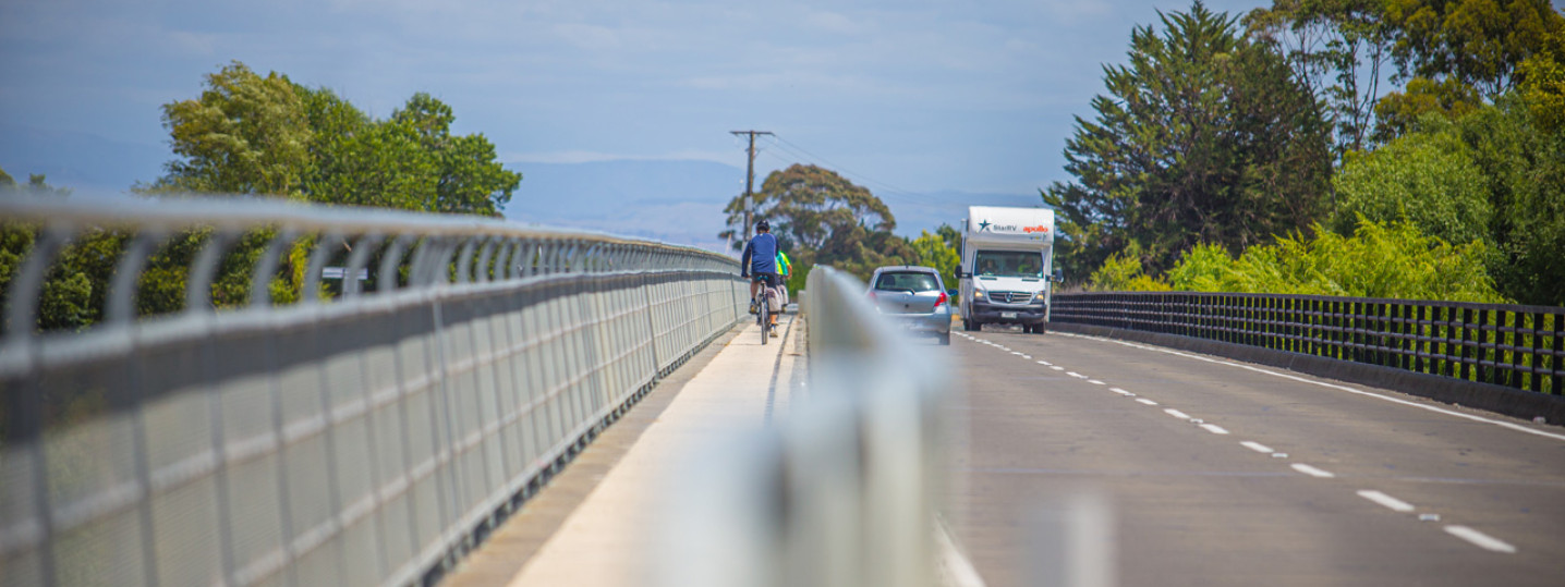 Bridge with a cyclist and cars on it